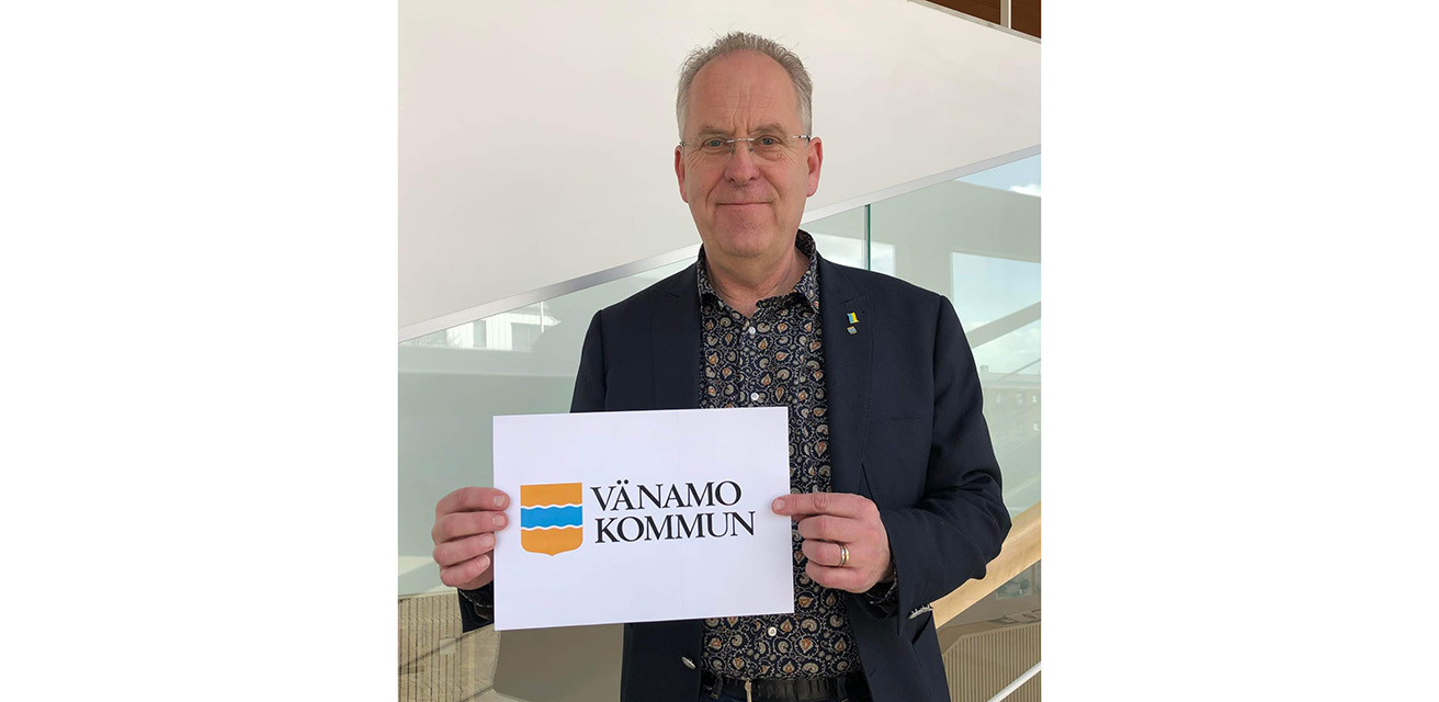 Ulf Svensson, kommundirektör, håller i ett ark papper med Värnamo kommuns logotyp, där R:et är bortsuddat.
